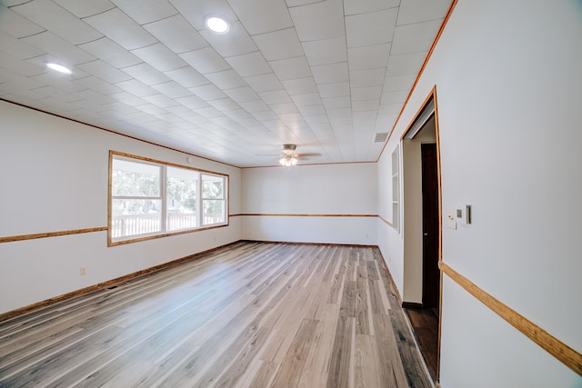 empty room with wood-type flooring, ceiling fan, and crown molding