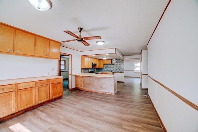 465 E Ash St, Watseka, IL 60970 - kitchen with a peninsula, light wood-style floors, ceiling fan, stove, and light countertops