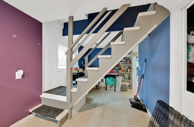 stairway with tile patterned flooring