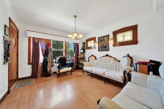 living room featuring an inviting chandelier, light wood-type flooring, and ornamental molding