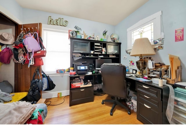 office area with light hardwood / wood-style floors and plenty of natural light