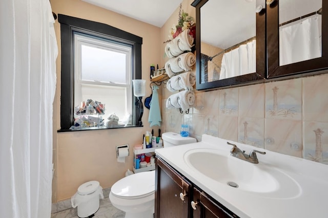 bathroom with walk in shower, vanity, and toilet