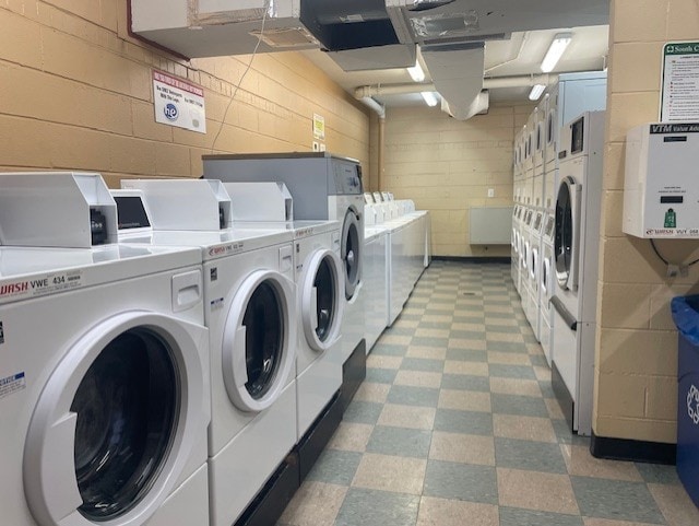 washroom with independent washer and dryer and stacked washer and clothes dryer