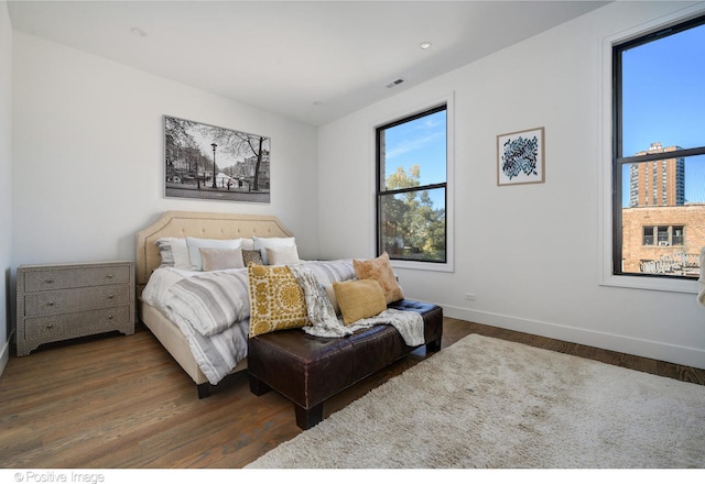 bedroom with dark wood-type flooring