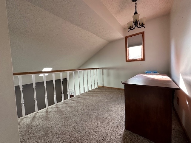 interior space featuring a notable chandelier, dark colored carpet, lofted ceiling, and a textured ceiling