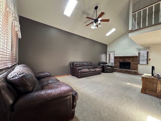 carpeted living room with a fireplace, ceiling fan, and high vaulted ceiling