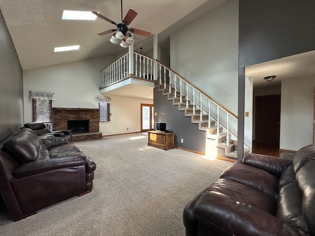 carpeted living room featuring high vaulted ceiling, ceiling fan, and a fireplace