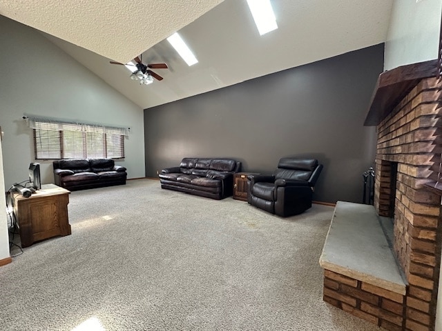 carpeted living room with a textured ceiling, a fireplace, ceiling fan, and high vaulted ceiling