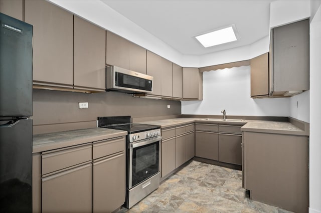 kitchen featuring gray cabinets, sink, and appliances with stainless steel finishes