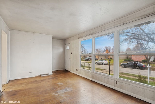 unfurnished room with hardwood / wood-style flooring