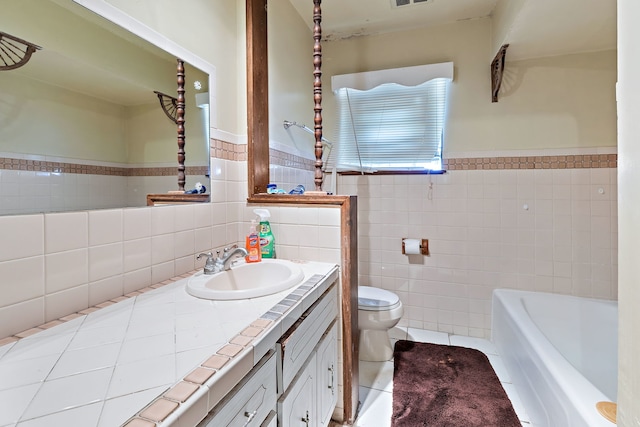 bathroom with vanity, a tub to relax in, toilet, and tile walls