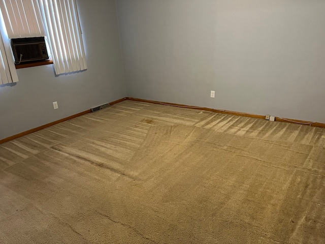 carpeted empty room with cooling unit and a fireplace