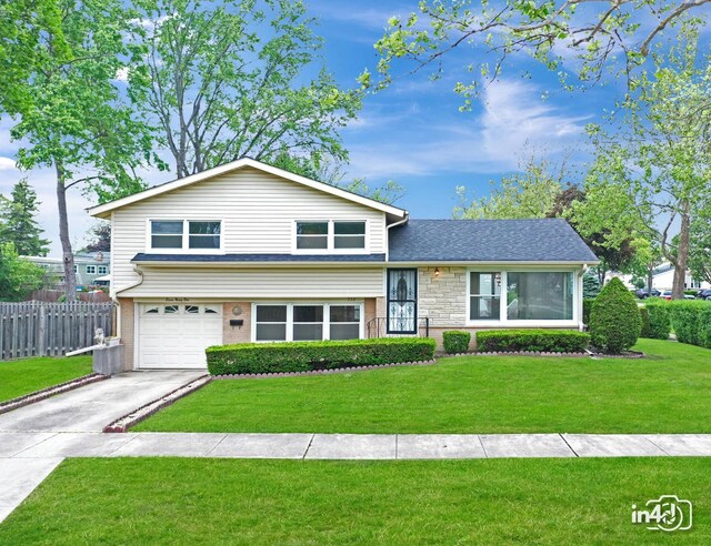 732 Luau Dr, Des Plaines, IL 60016 - split level home with an attached garage, driveway, and stone siding