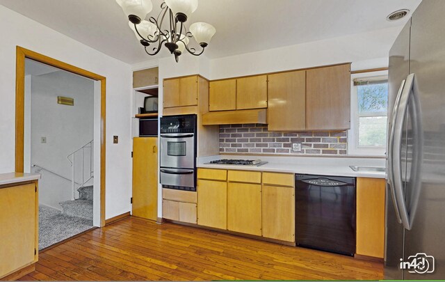 732 Luau Dr, Des Plaines, IL 60016 - kitchen featuring appliances with stainless steel finishes, light countertops, a warming drawer, dark wood-type flooring, and a chandelier
