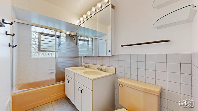 732 Luau Dr, Des Plaines, IL 60016 - full bath with tile walls, double vanity, toilet, and bath / shower combo with glass door