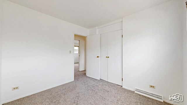 732 Luau Dr, Des Plaines, IL 60016 - unfurnished bedroom with carpet floors, baseboards, and a closet