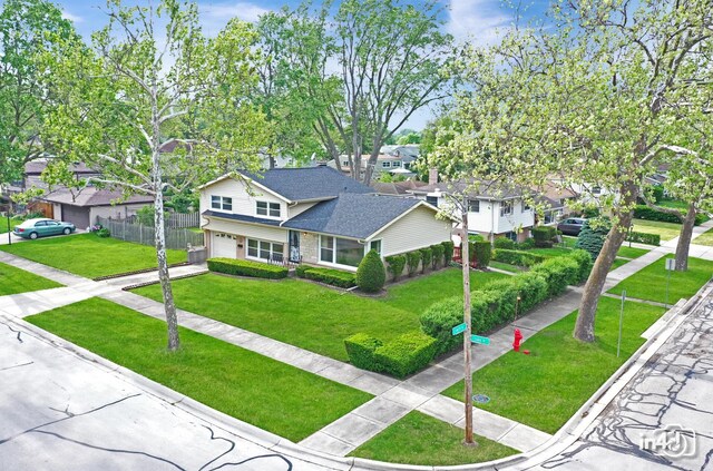 732 Luau Dr, Des Plaines, IL 60016 - traditional home featuring an attached garage, a residential view, driveway, brick siding, and a shingled roof