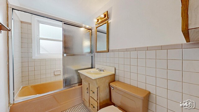 732 Luau Dr, Des Plaines, IL 60016 - bathroom featuring tile walls, toilet, vanity, enclosed tub / shower combo, and tile patterned floors