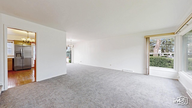 732 Luau Dr, Des Plaines, IL 60016 - unfurnished room featuring a chandelier, carpet flooring, and plenty of natural light