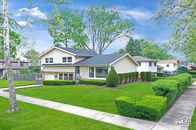 732 Luau Dr, Des Plaines, IL 60016 - split level home featuring a garage, stone siding, and driveway