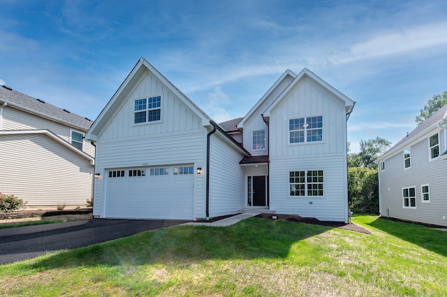 view of front facade with a garage and a front yard