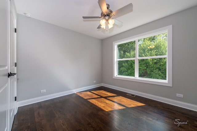 empty room with ceiling fan and dark wood-type flooring