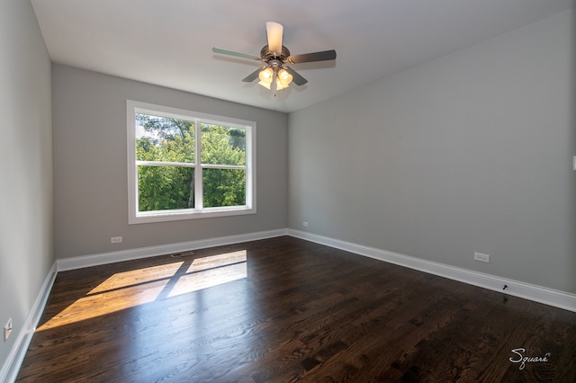 spare room with ceiling fan and dark wood-type flooring