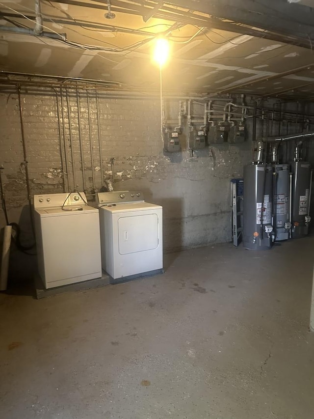 basement with washing machine and dryer and water heater