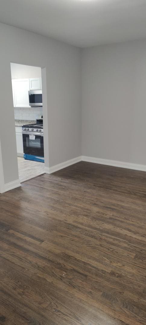 spare room with dark hardwood / wood-style floors