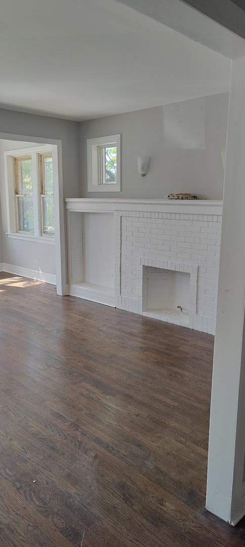 interior space featuring a fireplace and dark wood-type flooring