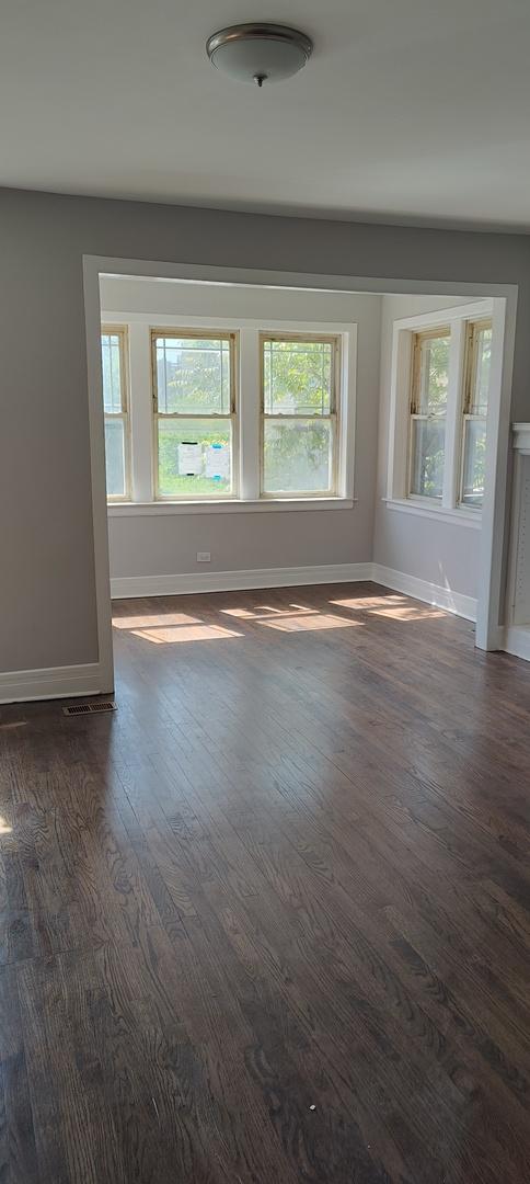 spare room with dark hardwood / wood-style flooring