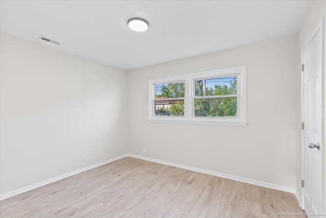 spare room featuring light wood-type flooring