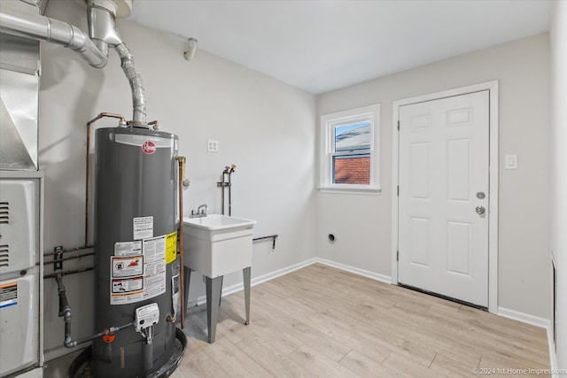 utility room featuring gas water heater