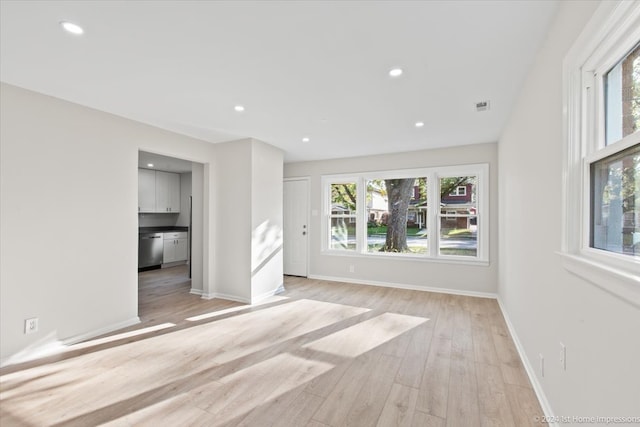 empty room with light hardwood / wood-style flooring