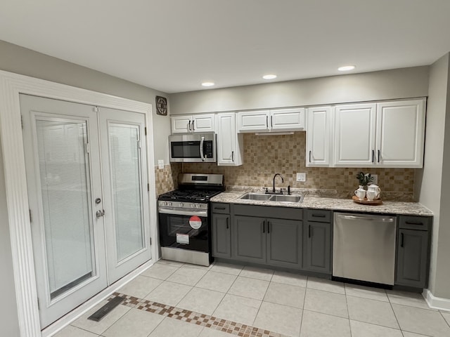 kitchen featuring gray cabinetry, white cabinetry, sink, and appliances with stainless steel finishes