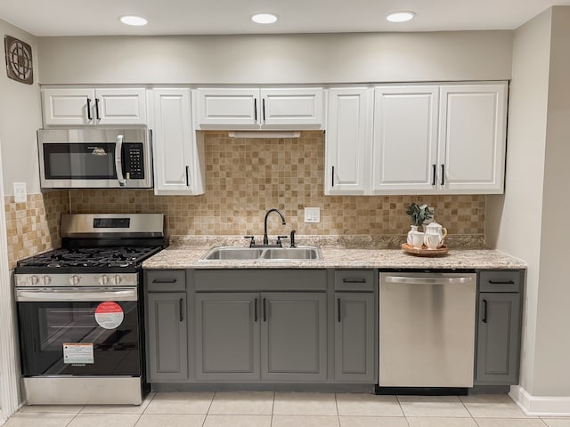 kitchen with gray cabinets, sink, and appliances with stainless steel finishes