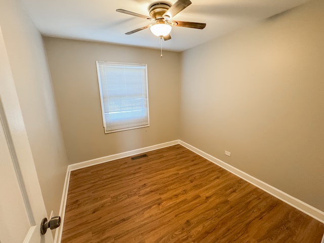 empty room with ceiling fan and wood-type flooring