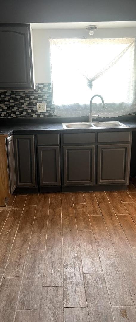 1249 Cunningham Dr Unit 3E, Calumet City, IL 60409 - kitchen featuring a sink, dark wood finished floors, dark countertops, and decorative backsplash