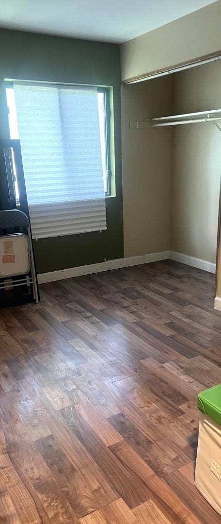 1249 Cunningham Dr Unit 3E, Calumet City, IL 60409 - unfurnished bedroom with wood finished floors, a closet, and baseboards