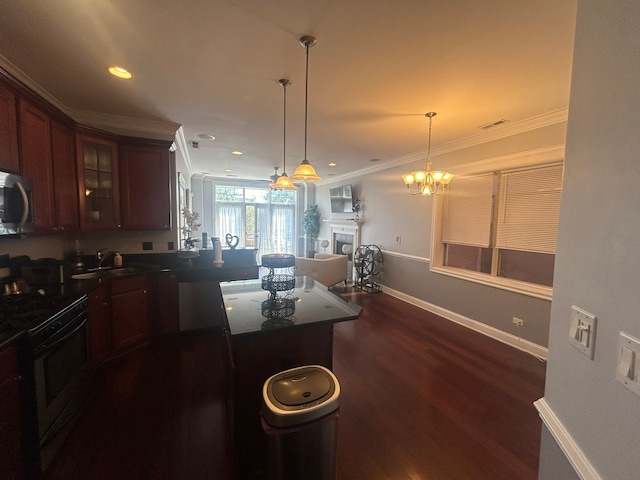 kitchen featuring hanging light fixtures, ornamental molding, sink, dark hardwood / wood-style floors, and electric stove