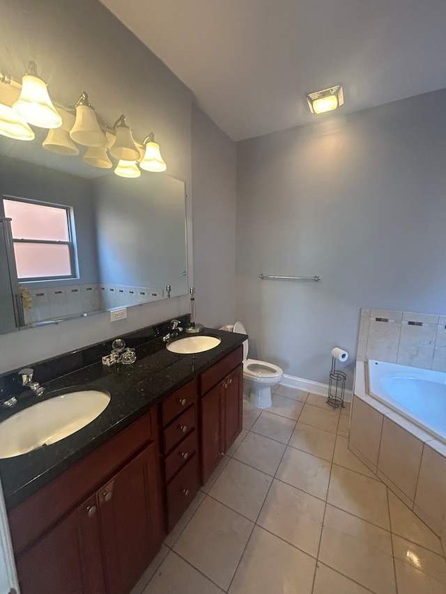 bathroom featuring tiled tub, vanity, toilet, and tile patterned floors