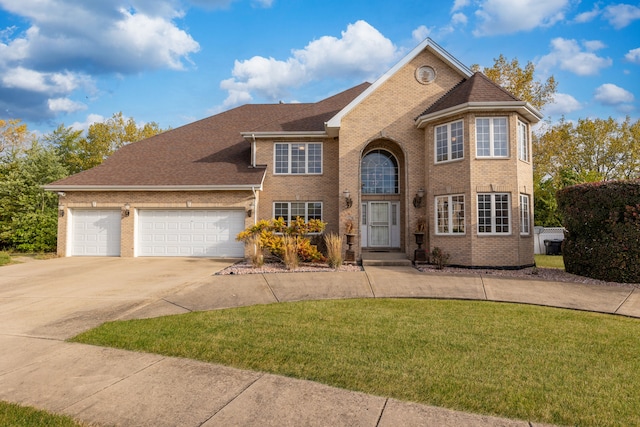 view of front facade with a front lawn and a garage