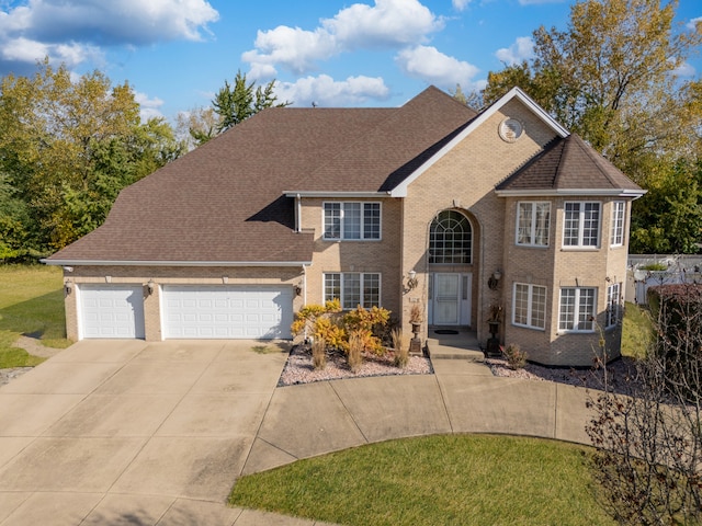 view of front facade featuring a front yard and a garage