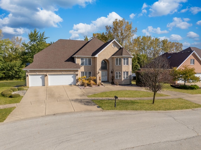 front facade with a garage and a front lawn