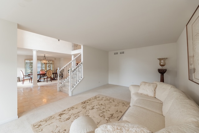 carpeted living room featuring a notable chandelier