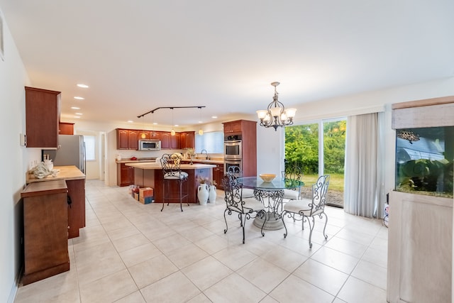 dining room featuring an inviting chandelier and light tile patterned floors