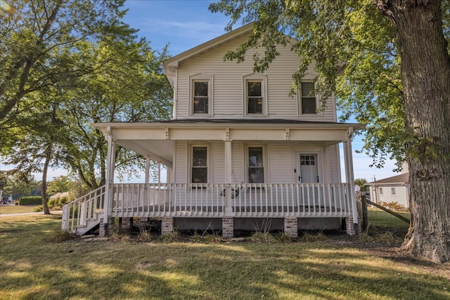 farmhouse inspired home featuring a porch and a front lawn