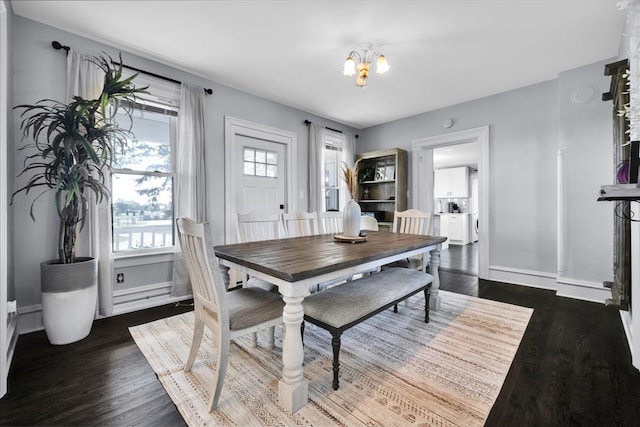 dining area featuring a notable chandelier and dark hardwood / wood-style flooring