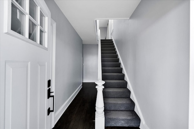 stairs featuring wood-type flooring