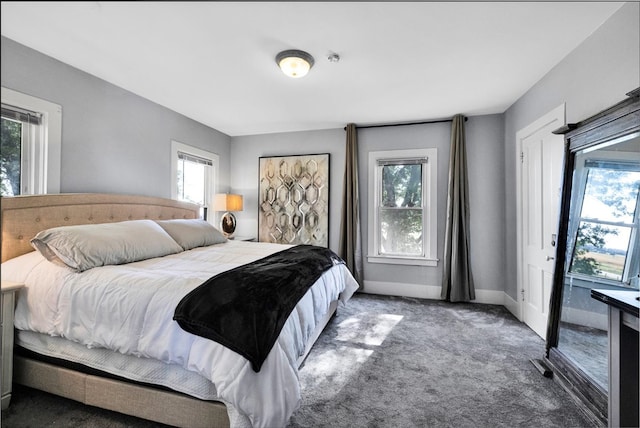 carpeted bedroom featuring multiple windows